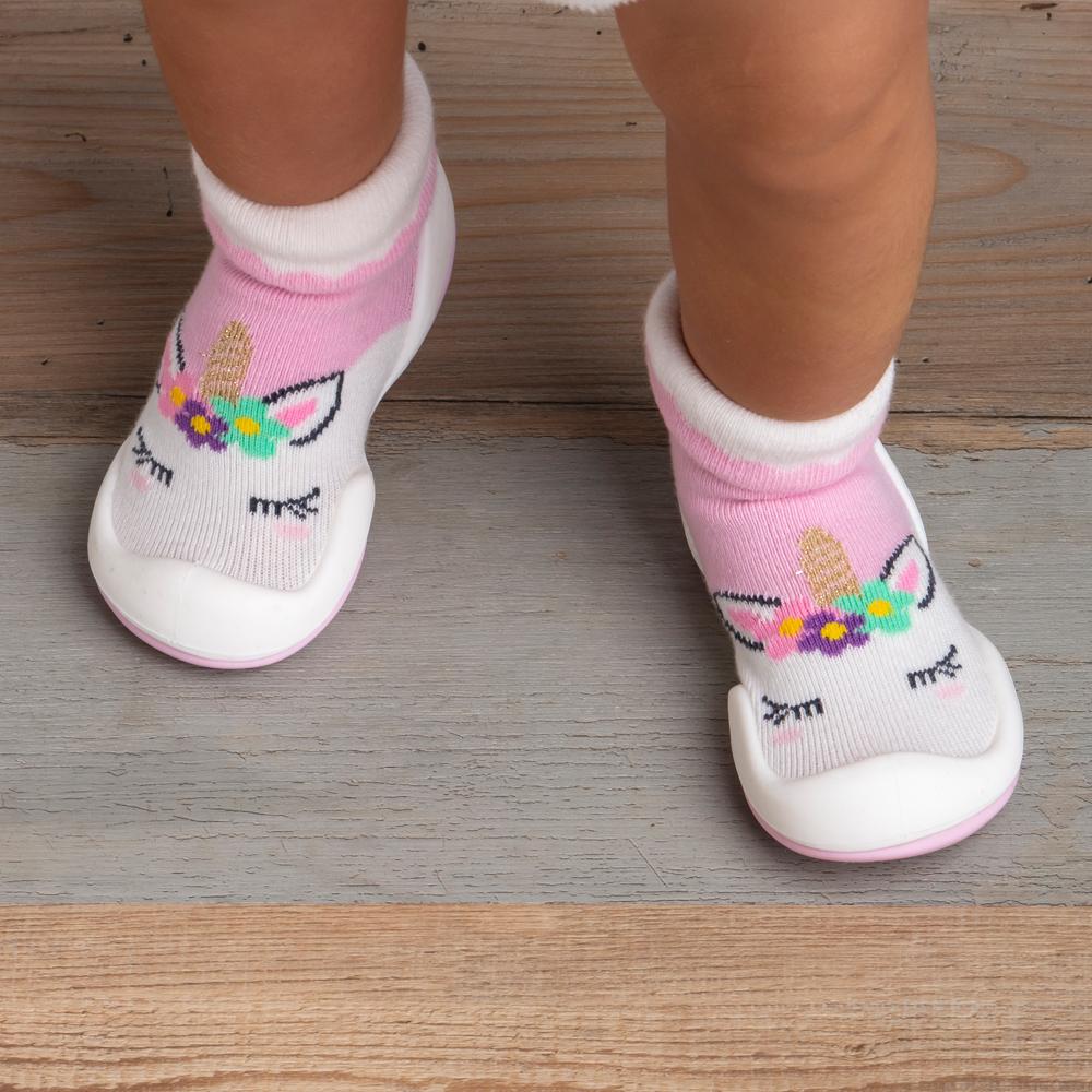 Baby wearing unicorn socks-shoes.