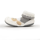 Child's white sock shoe with gray trim and tan animal pattern.