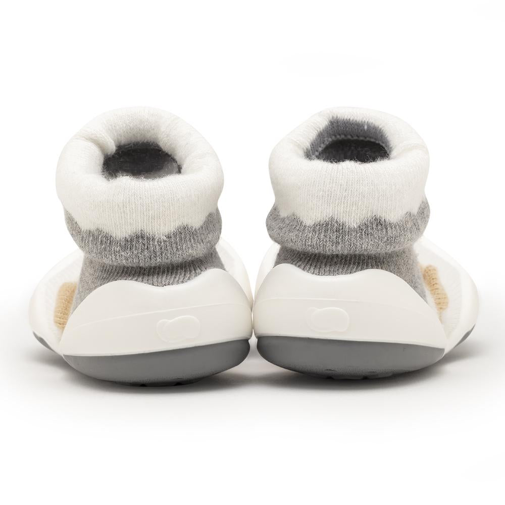 Two baby shoes with white and gray sock-like tops and white and gray soles.