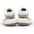 Two baby shoes with white and gray sock-like tops and white and gray soles.