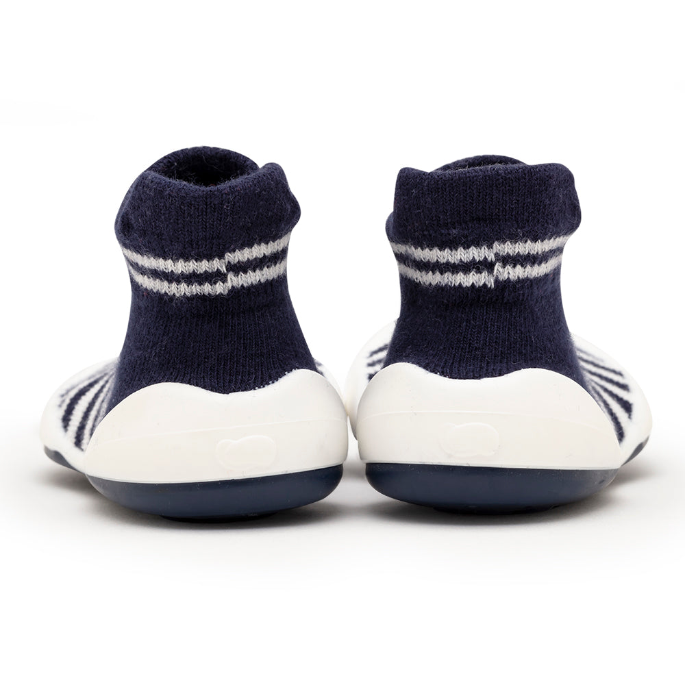 Two navy and white striped sock shoes, back view.