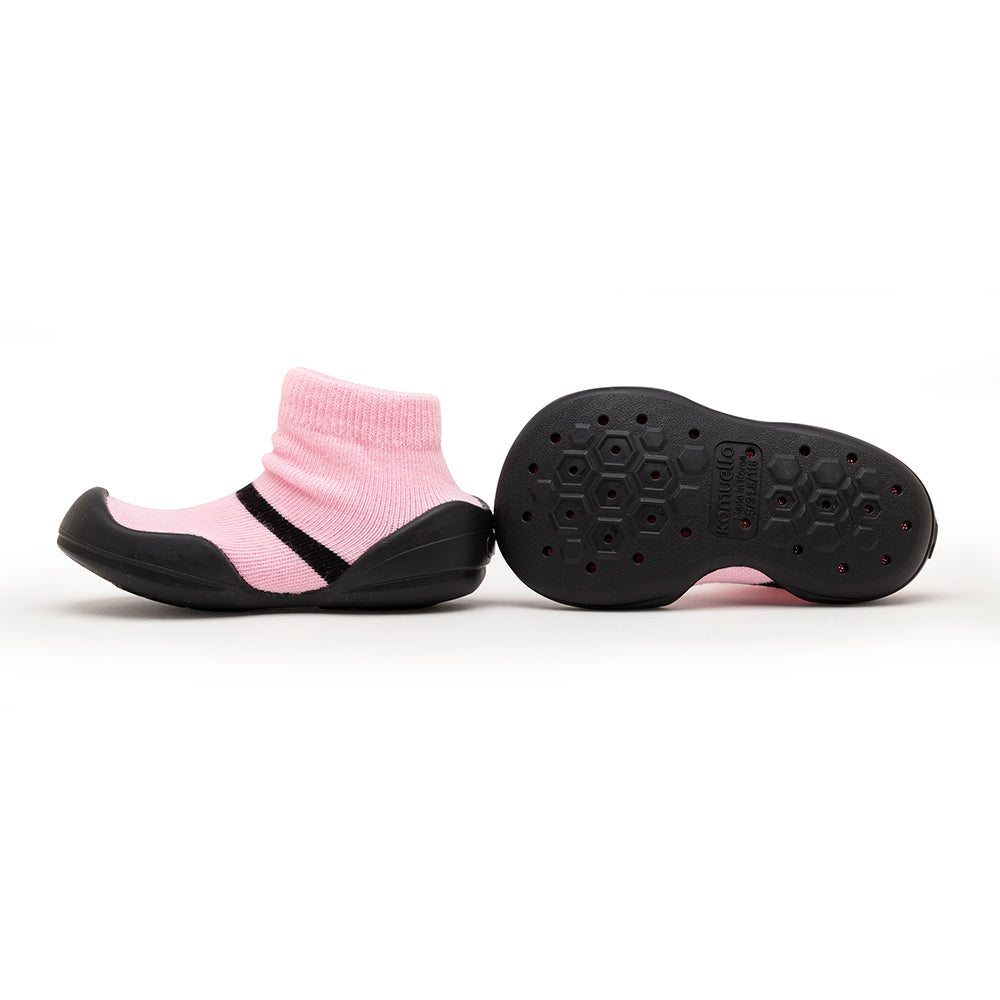 Pink sock shoes with black soles.