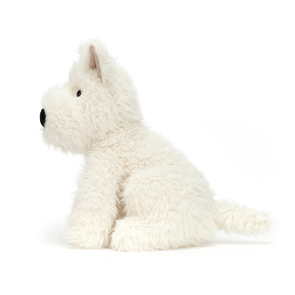 A white plush West Highland Terrier sits in profile.