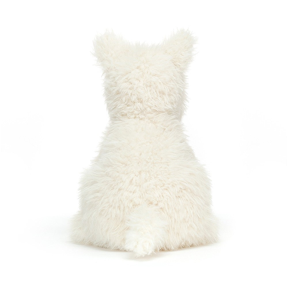 Back of a fluffy, white toy dog sitting.
