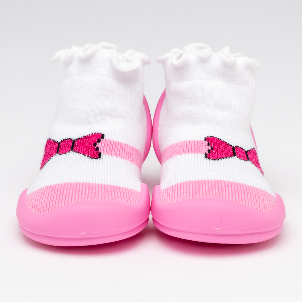 Pair of pink and white baby shoes with bow.