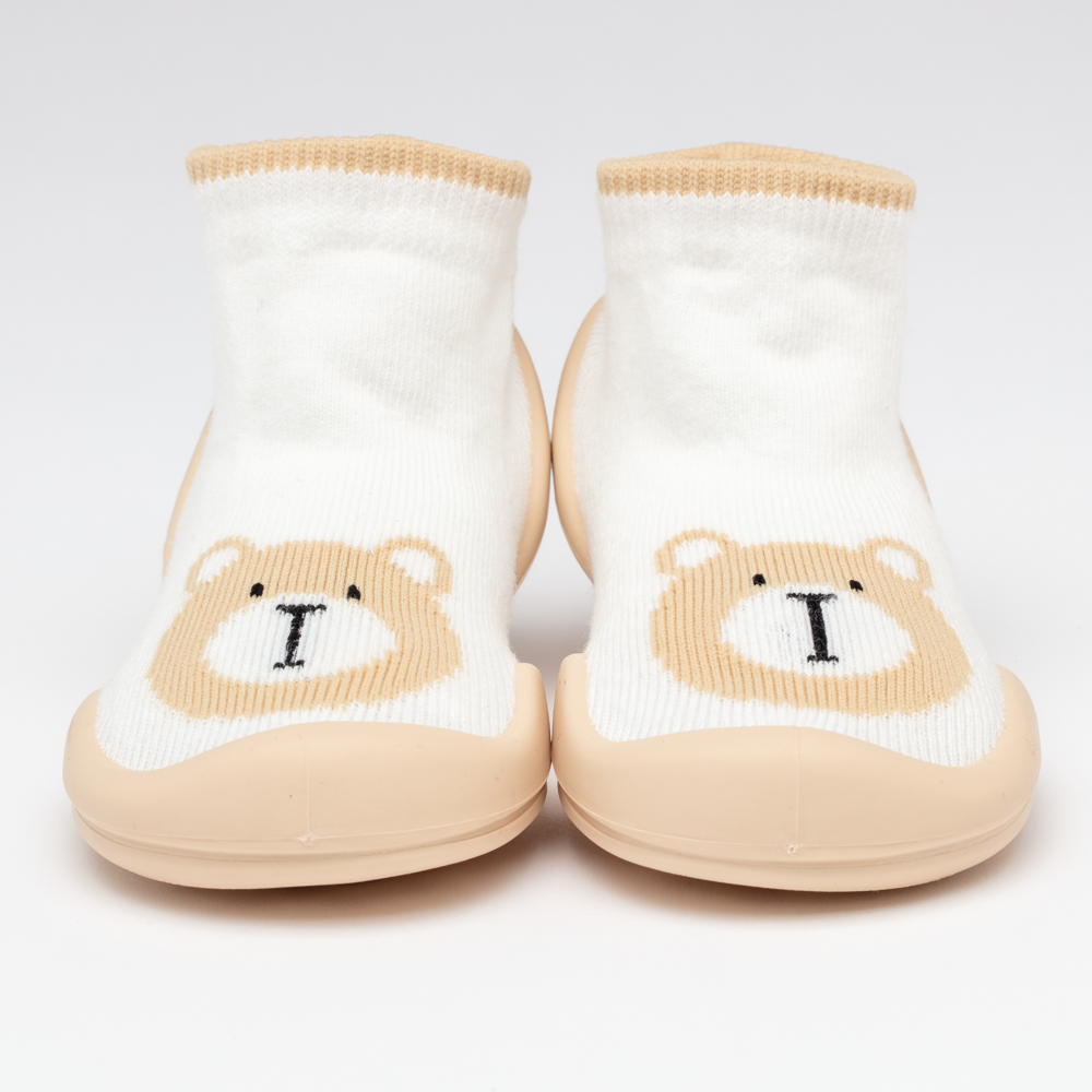 Pair of baby socks with tan bear faces and matching rubber soles.