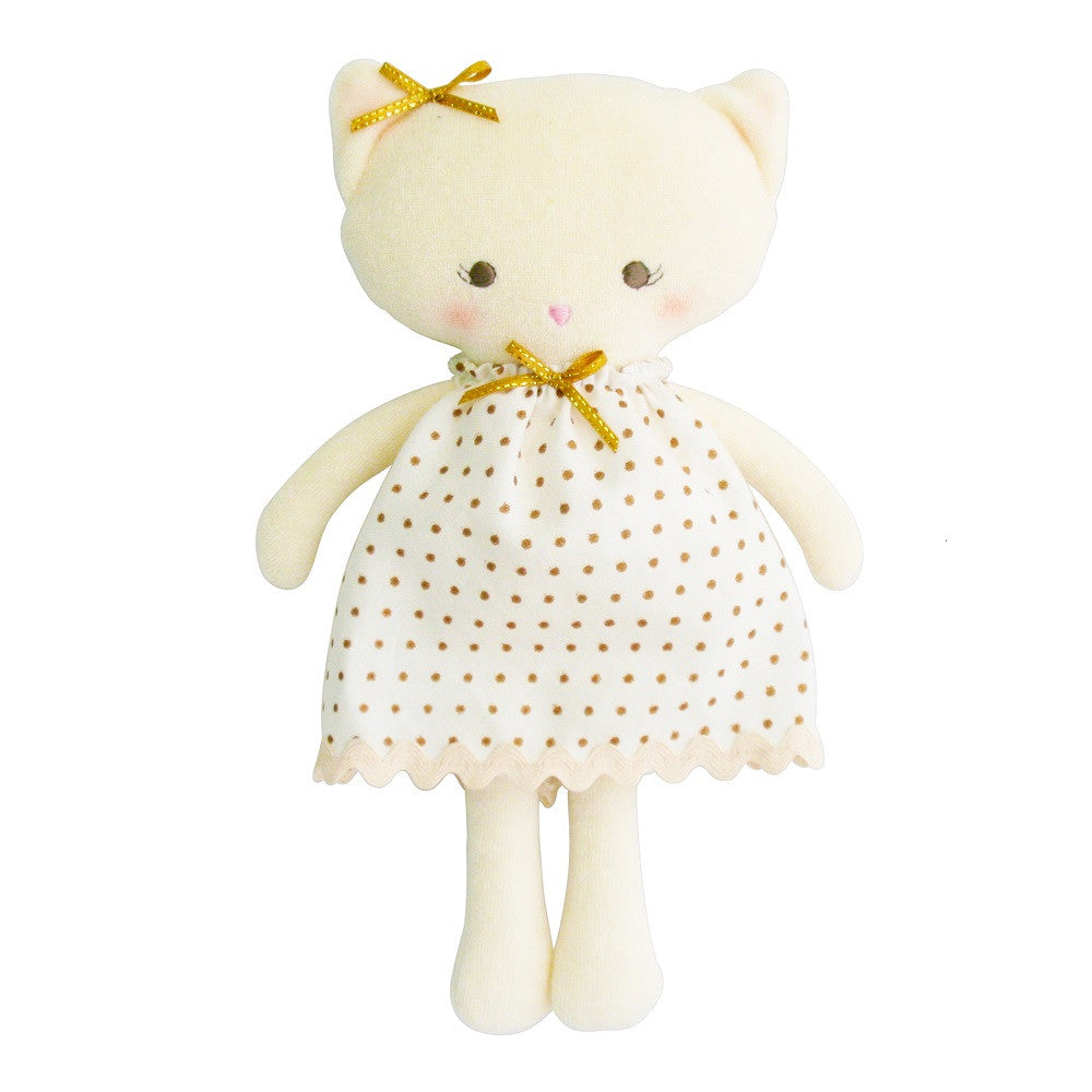 Stuffed cat doll in a polka-dot dress.