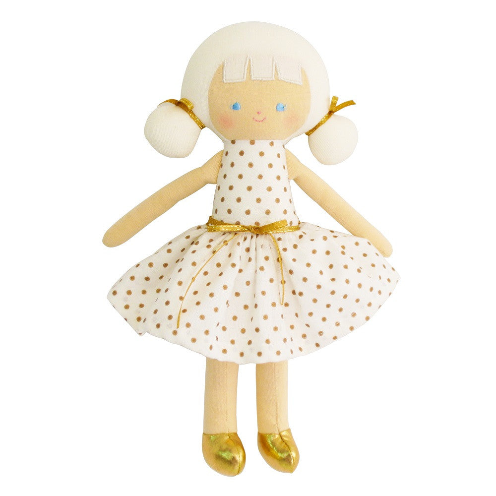 Plush doll in white polka dot dress with gold shoes.