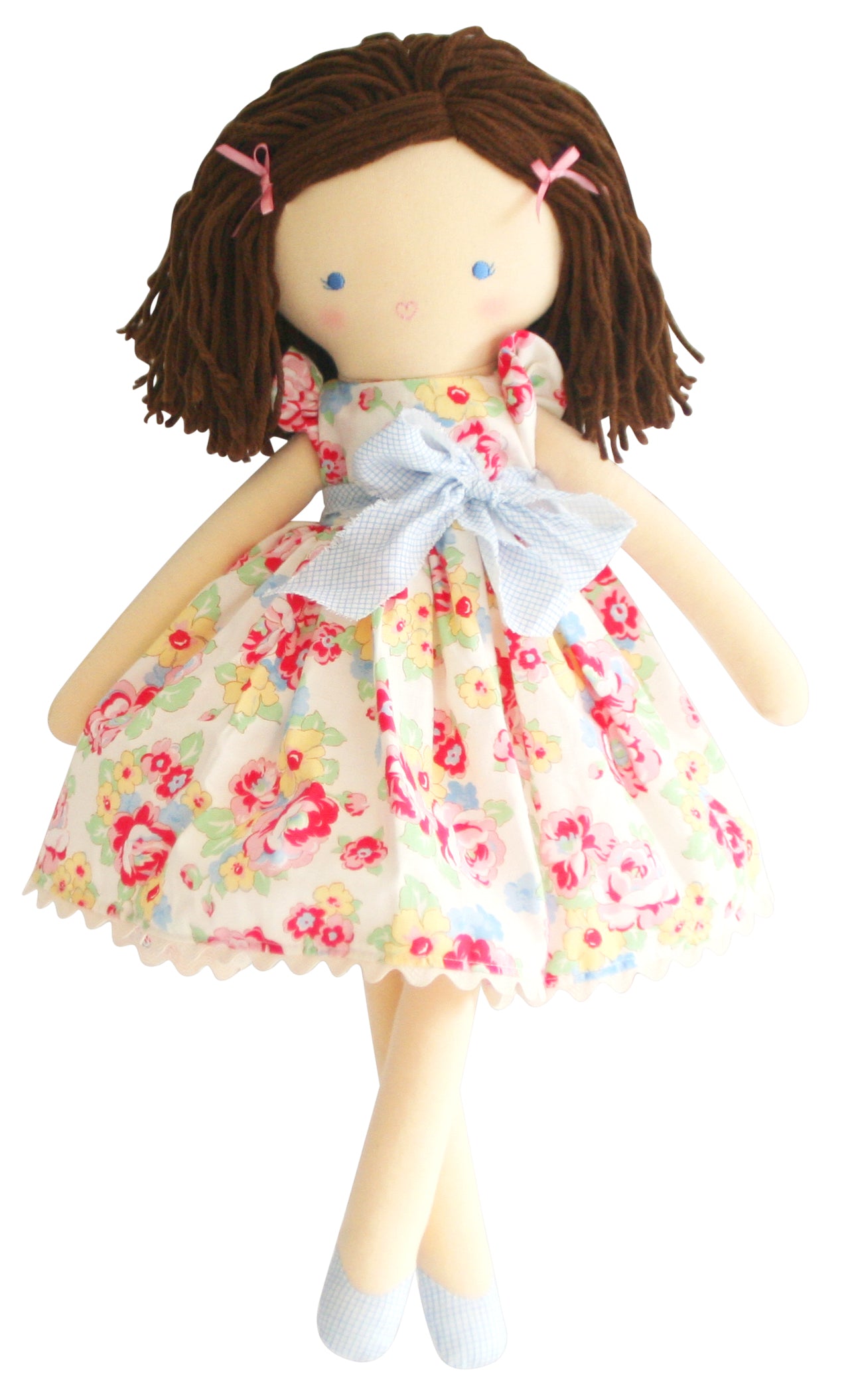 Rag doll with brown yarn hair, floral dress, and blue ribbon.