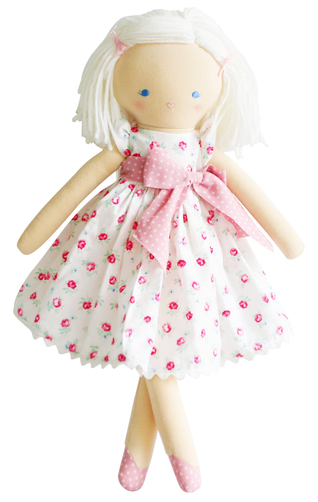 Rag doll with white hair wearing a floral dress and pink polka dot bow.