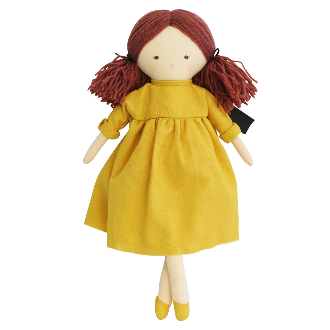 Rag doll in yellow dress with red yarn hair.