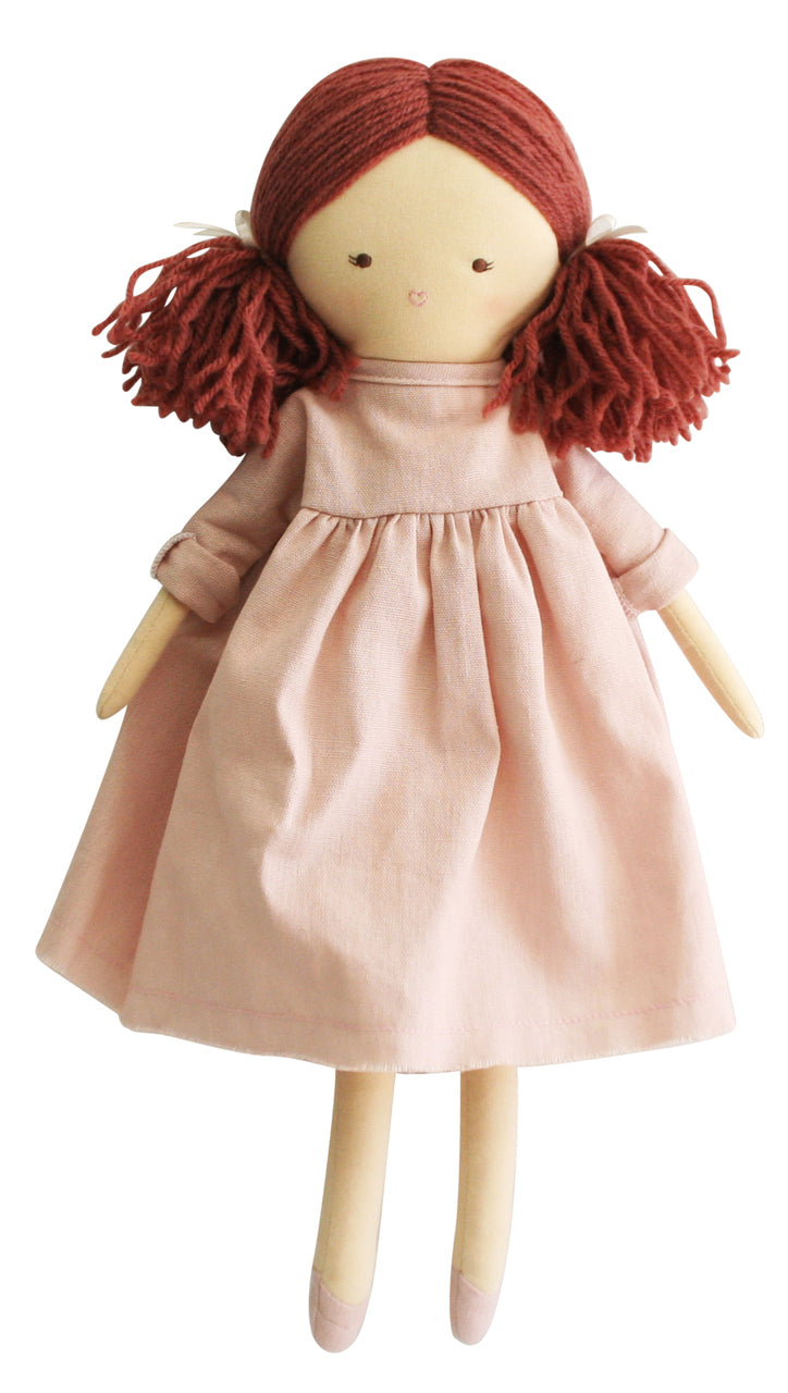 Cloth doll with red yarn hair and a pink dress.
