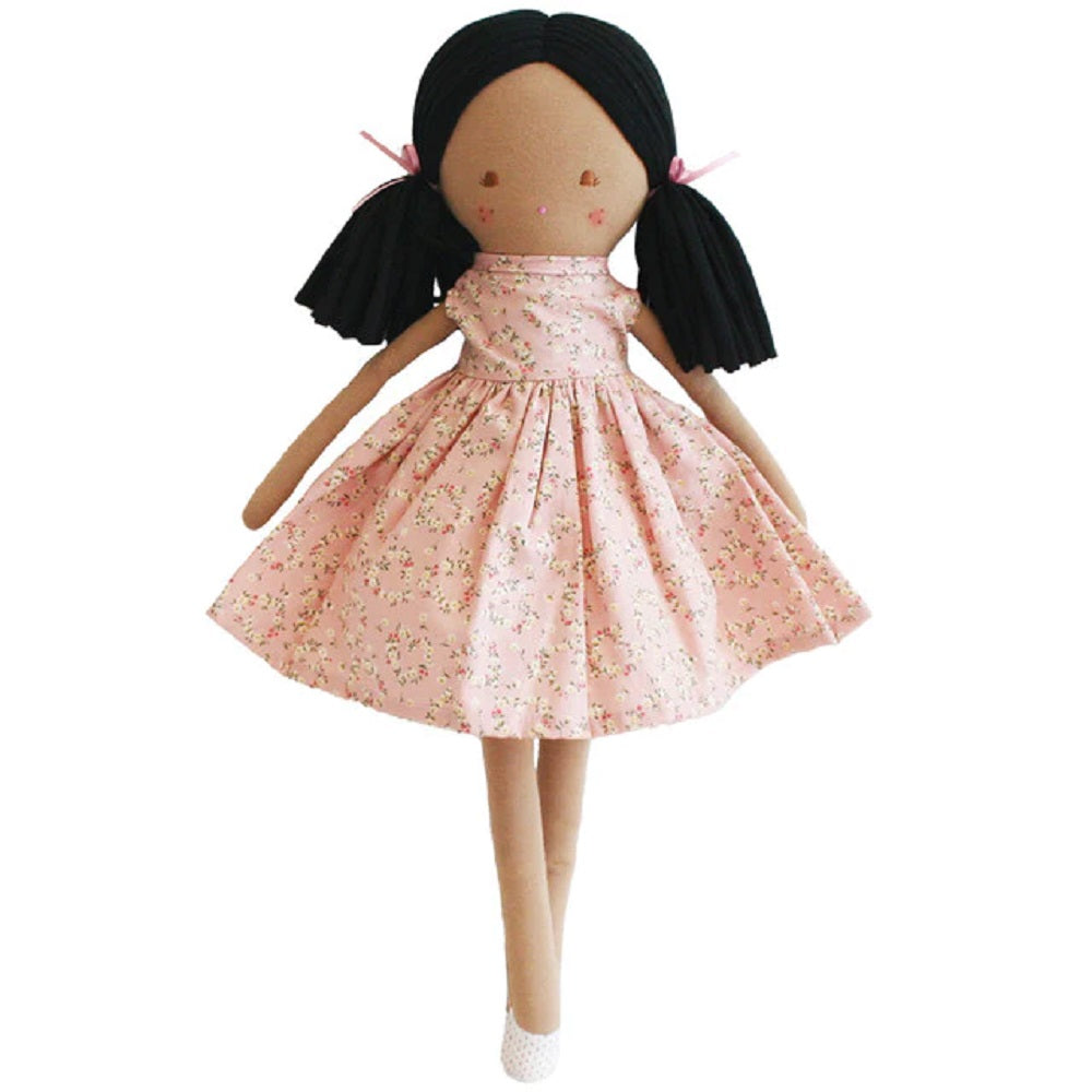 Stuffed doll in a pink floral dress with black hair in pigtails.