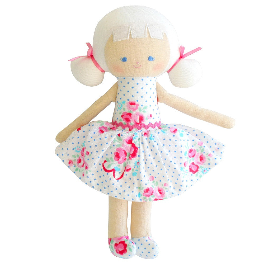 Rag doll with white hair, polka dot floral dress, and pink ribbons.