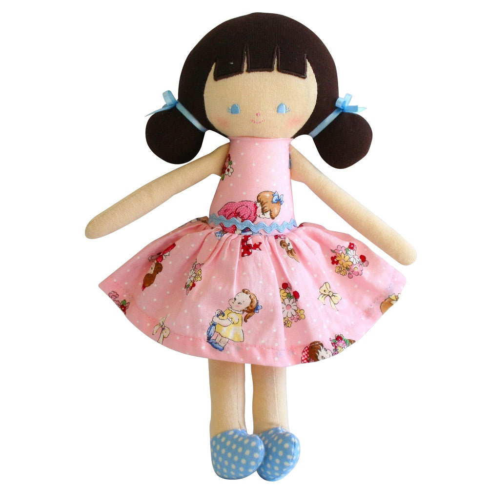 Rag doll with brown hair, blue polka dot shoes, and a pink patterned dress.