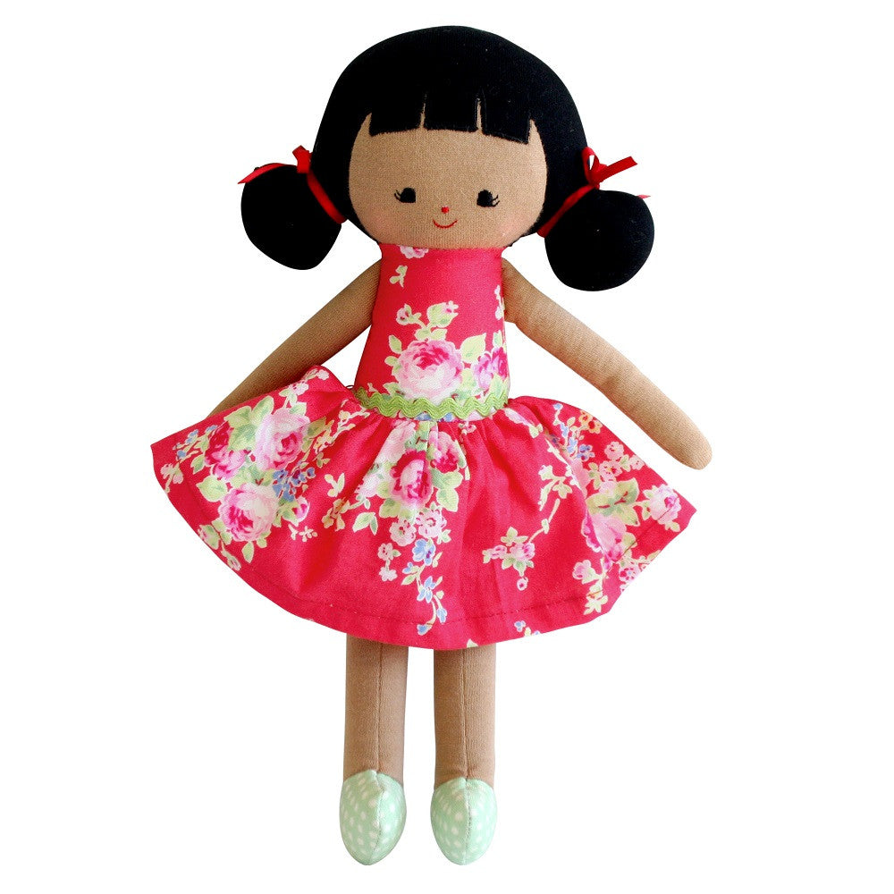 Plush doll with black hair, red floral dress, and polka dot shoes.