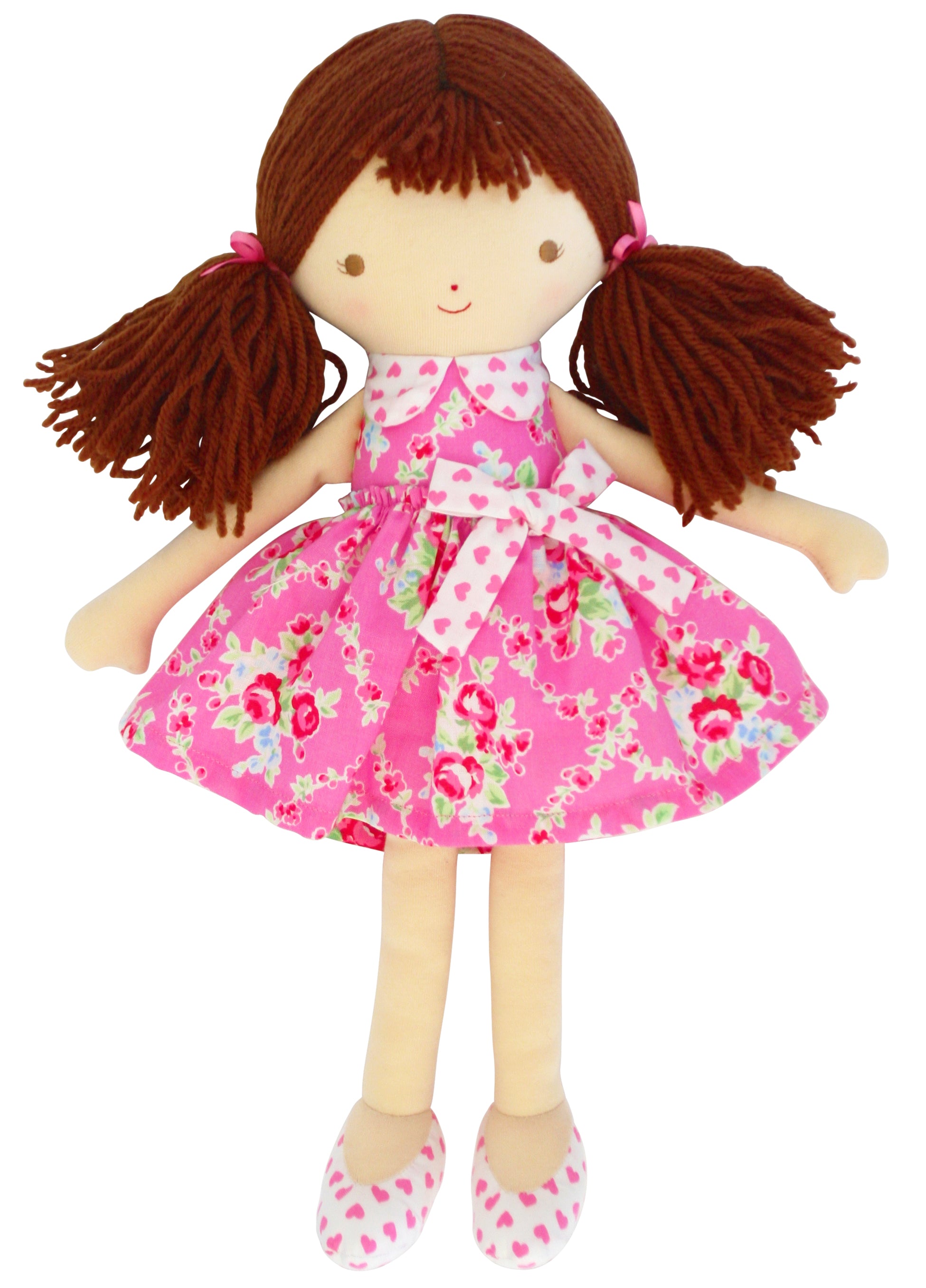 Plush ragdoll with brown yarn hair in pigtails, pink floral dress, heart-patterned shoes.