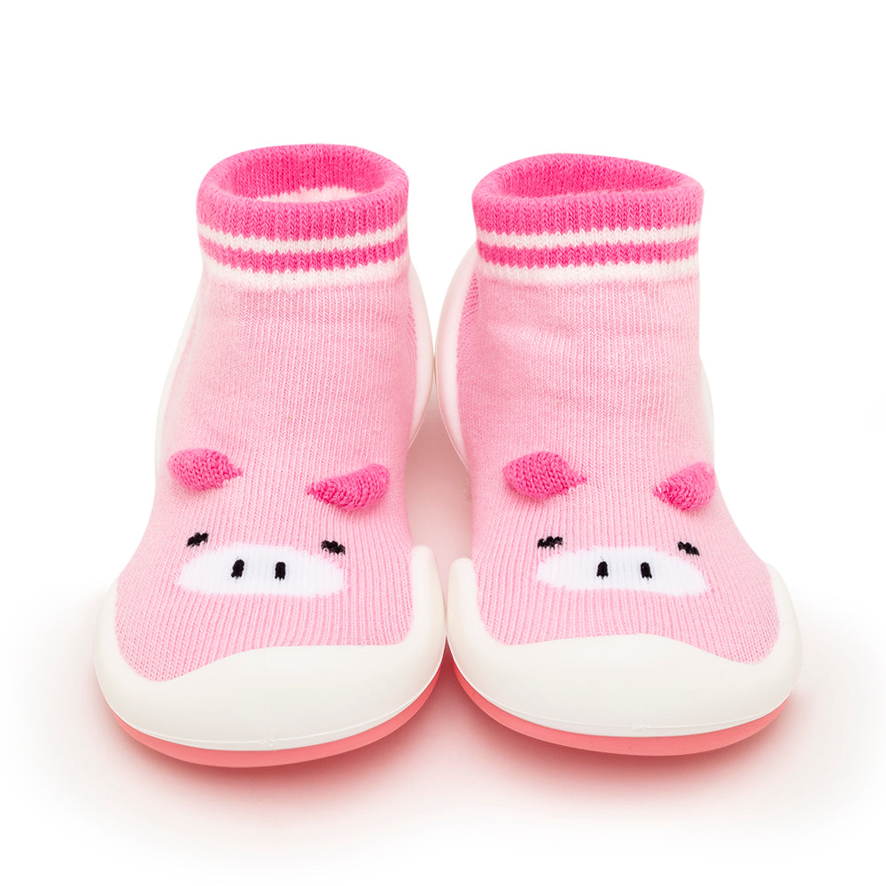 Pink baby sock shoes with pig design.