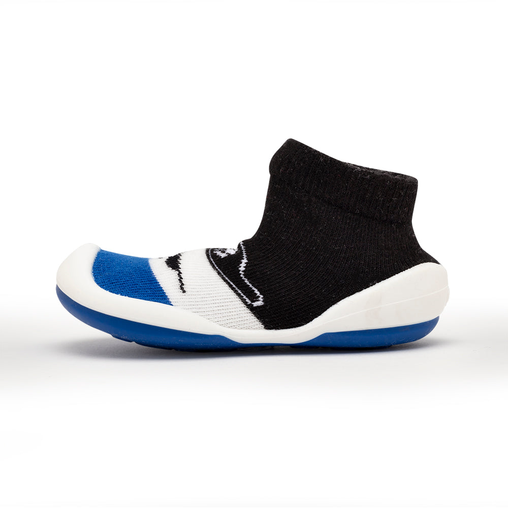 Sock-style baby shoe with black, white, and blue color scheme.