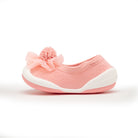 Pink knitted toddler shoe with floral detail.