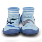 Two blue baby slipper socks with a shark design.