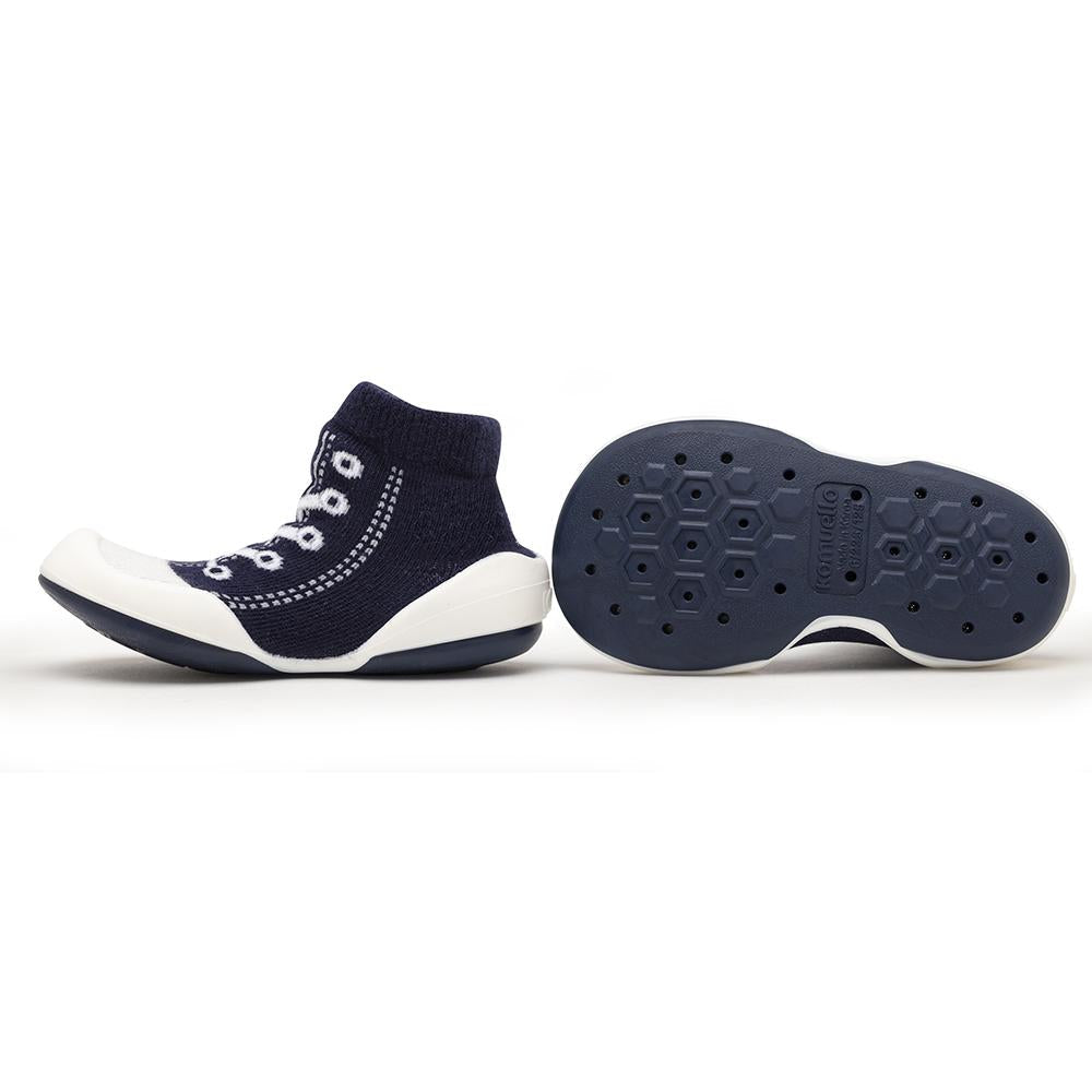 Navy blue sock-shoe, white rubber sole, eyelet details.