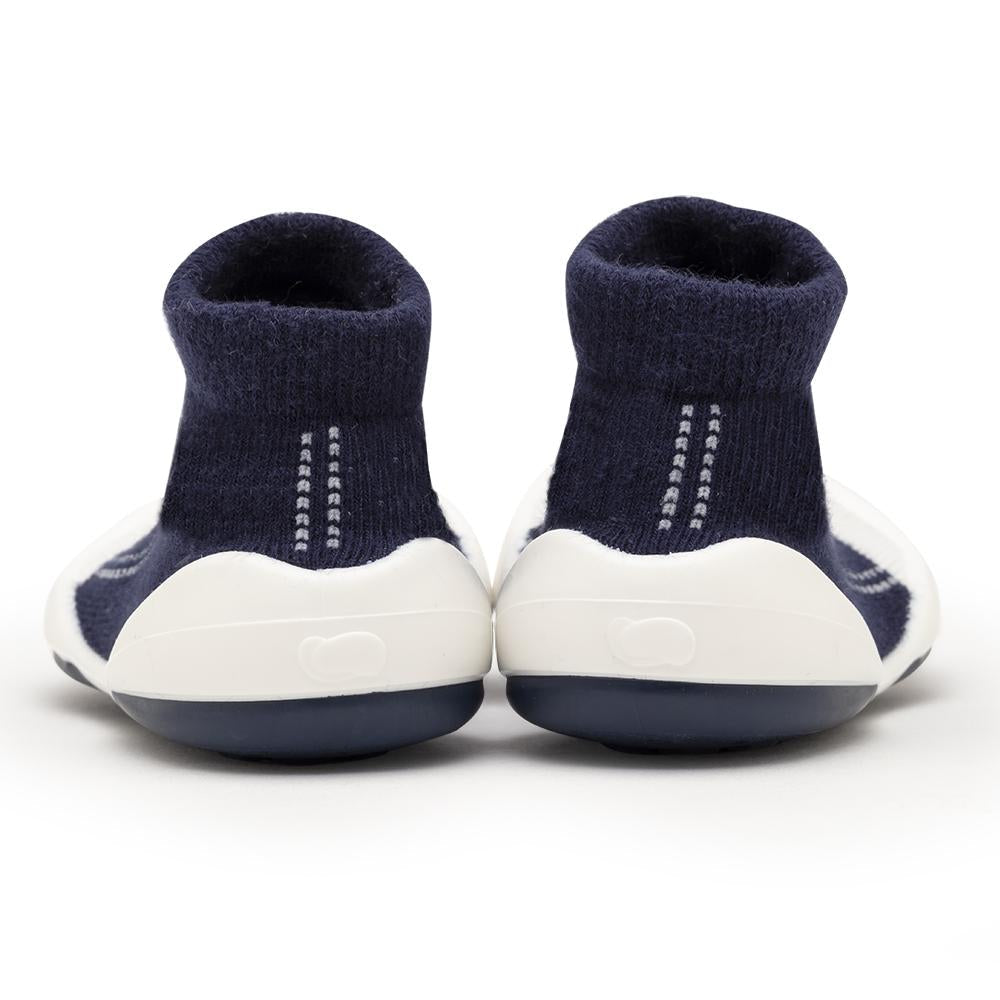 Two navy blue and white baby sock shoes.
