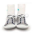 A pair of baby shoe socks, white with a gray sneaker pattern.