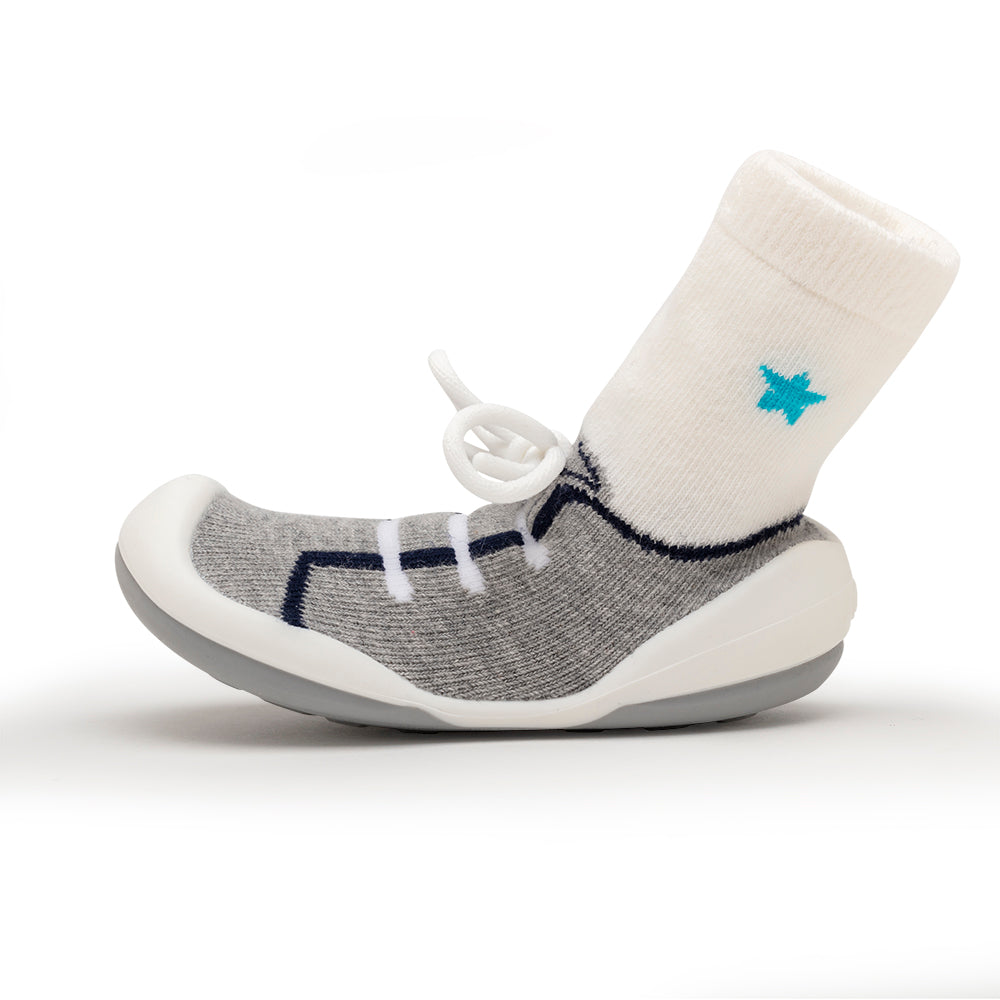 Gray sock-shoe with white sock and blue star.