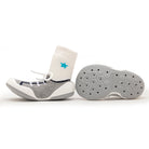 One gray and white baby sock shoe with a white sock and a star, next to its grey sole.