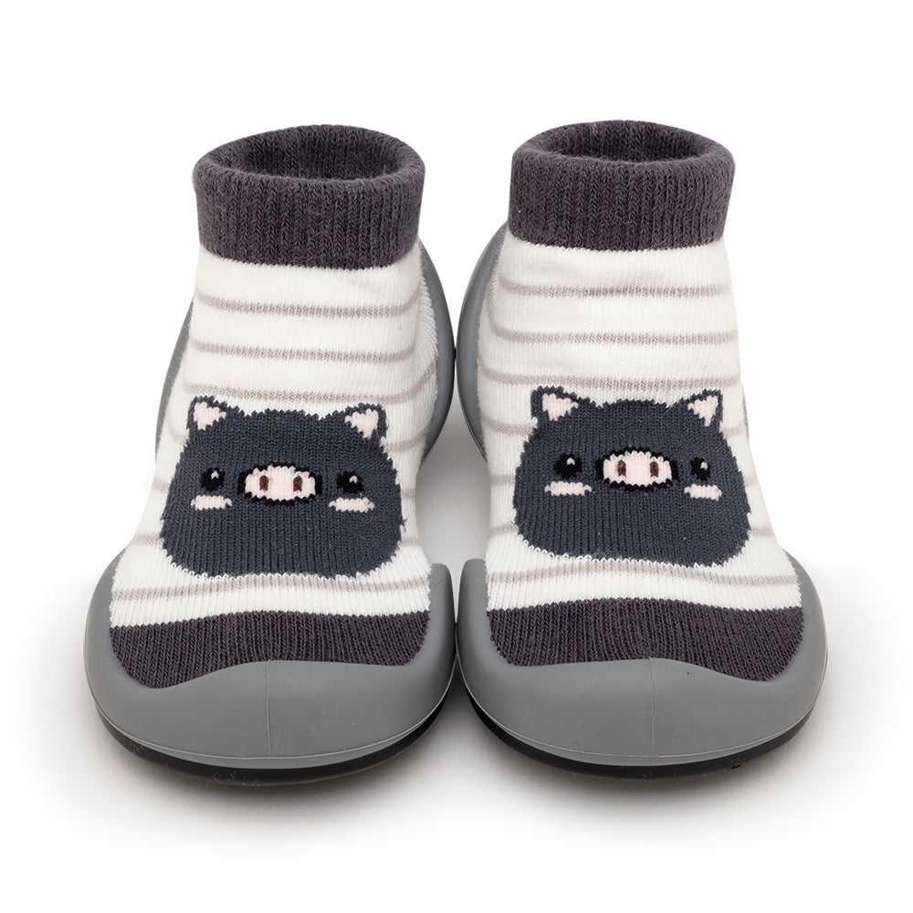 Two gray and white striped baby socks with pig faces.