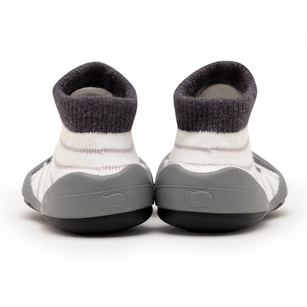 Back view of gray and white striped baby shoes.