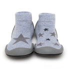 Front view of baby blue sock shoes with star print and gray rubber soles.