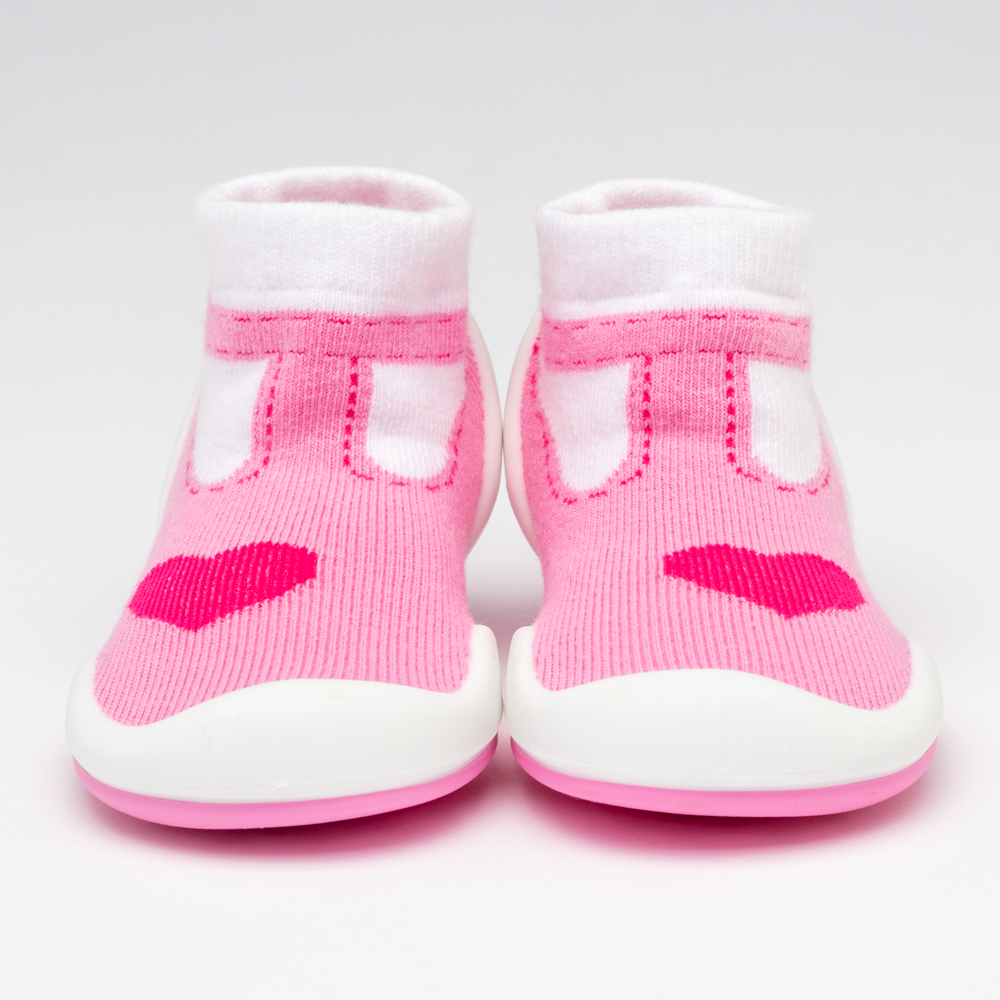 Pair of pink and white baby shoes with hearts.