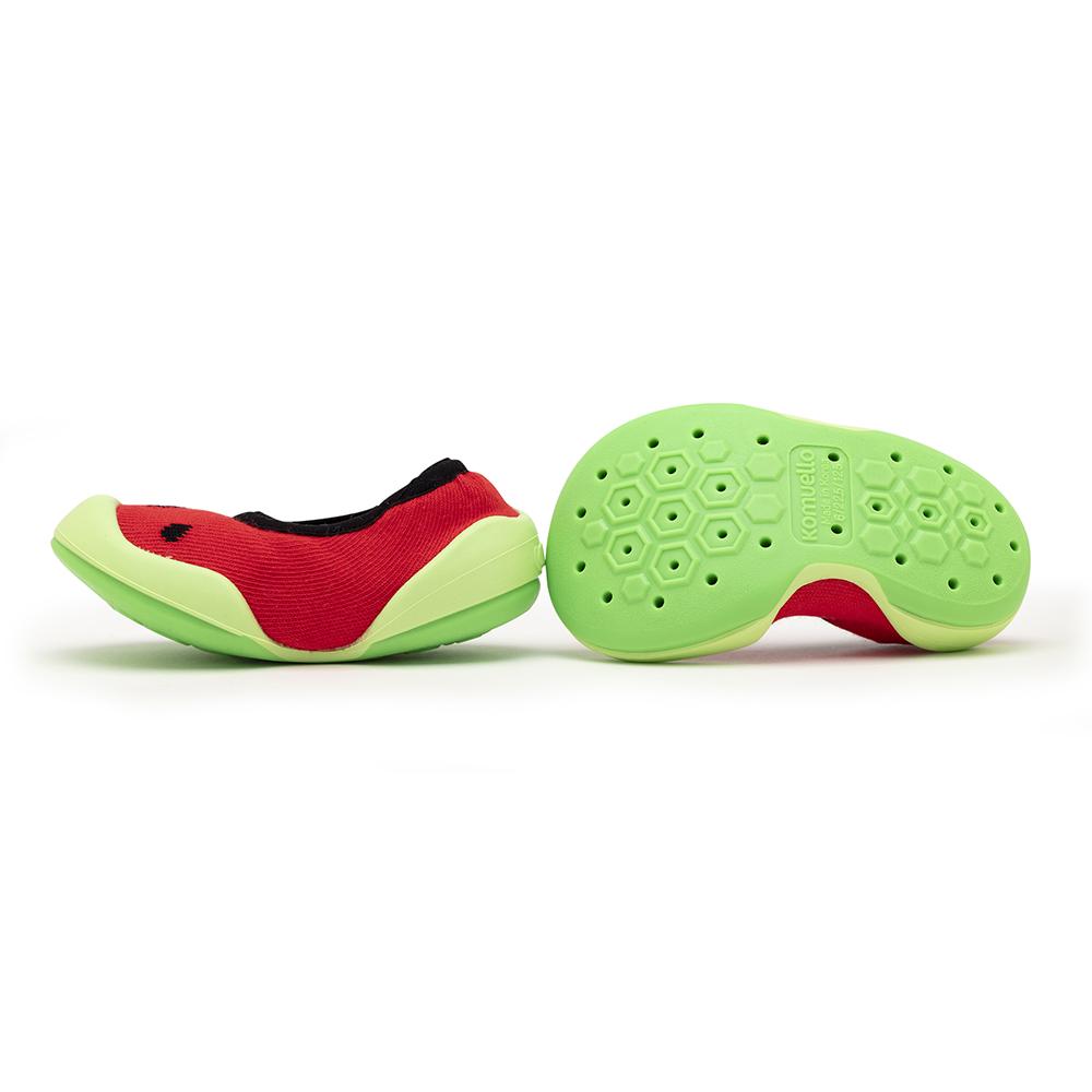 Two watermelon-themed Kumuelle shoes, one lying on its side, the other with the sole facing up.