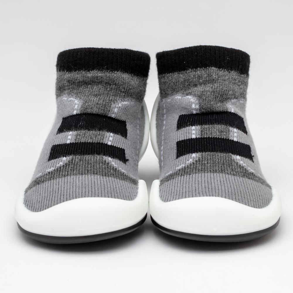 Two gray sock shoes with black stripes and white soles.