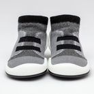 Two gray sock shoes with black stripes and white soles.