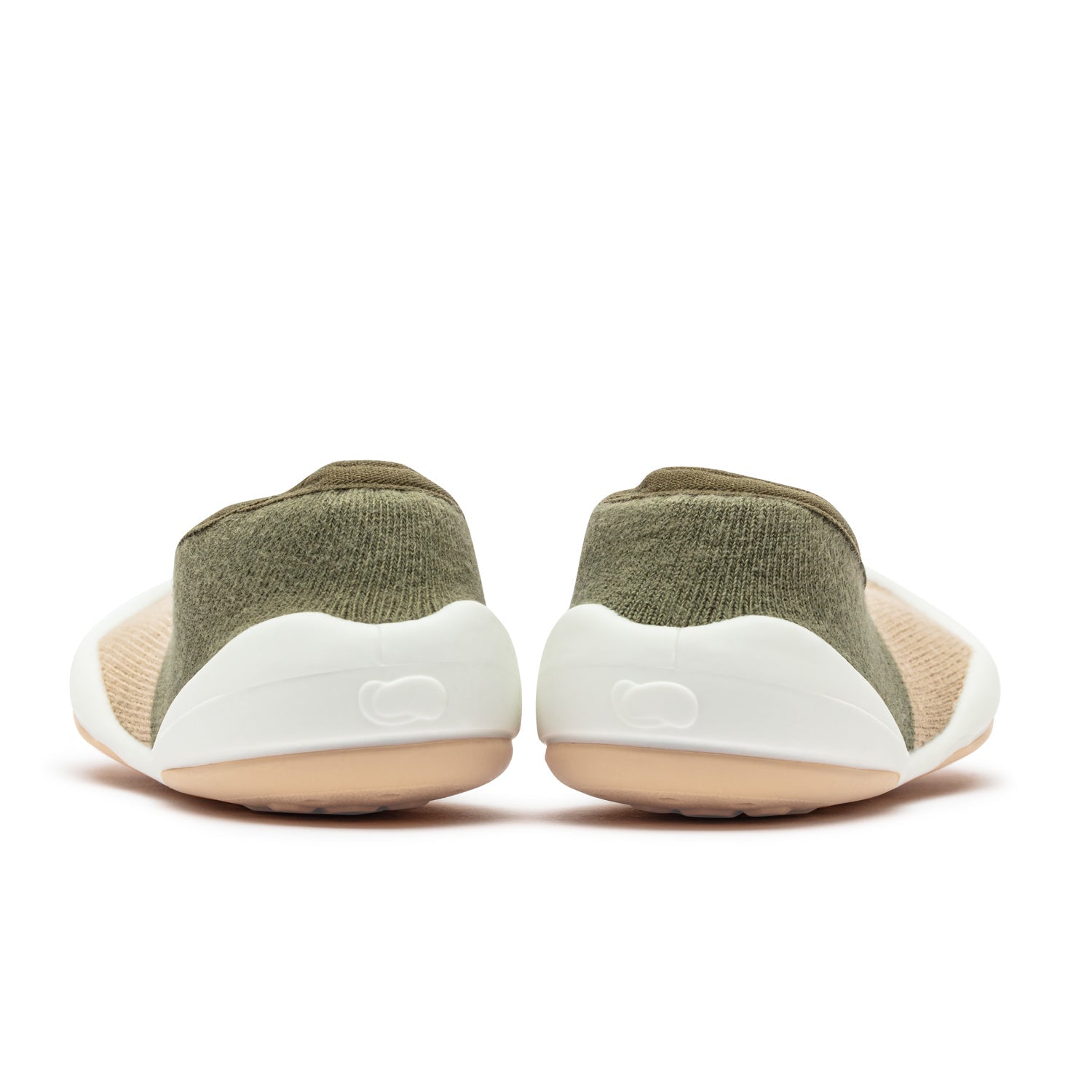 Back view of a pair of light green baby shoes with white rubber soles.