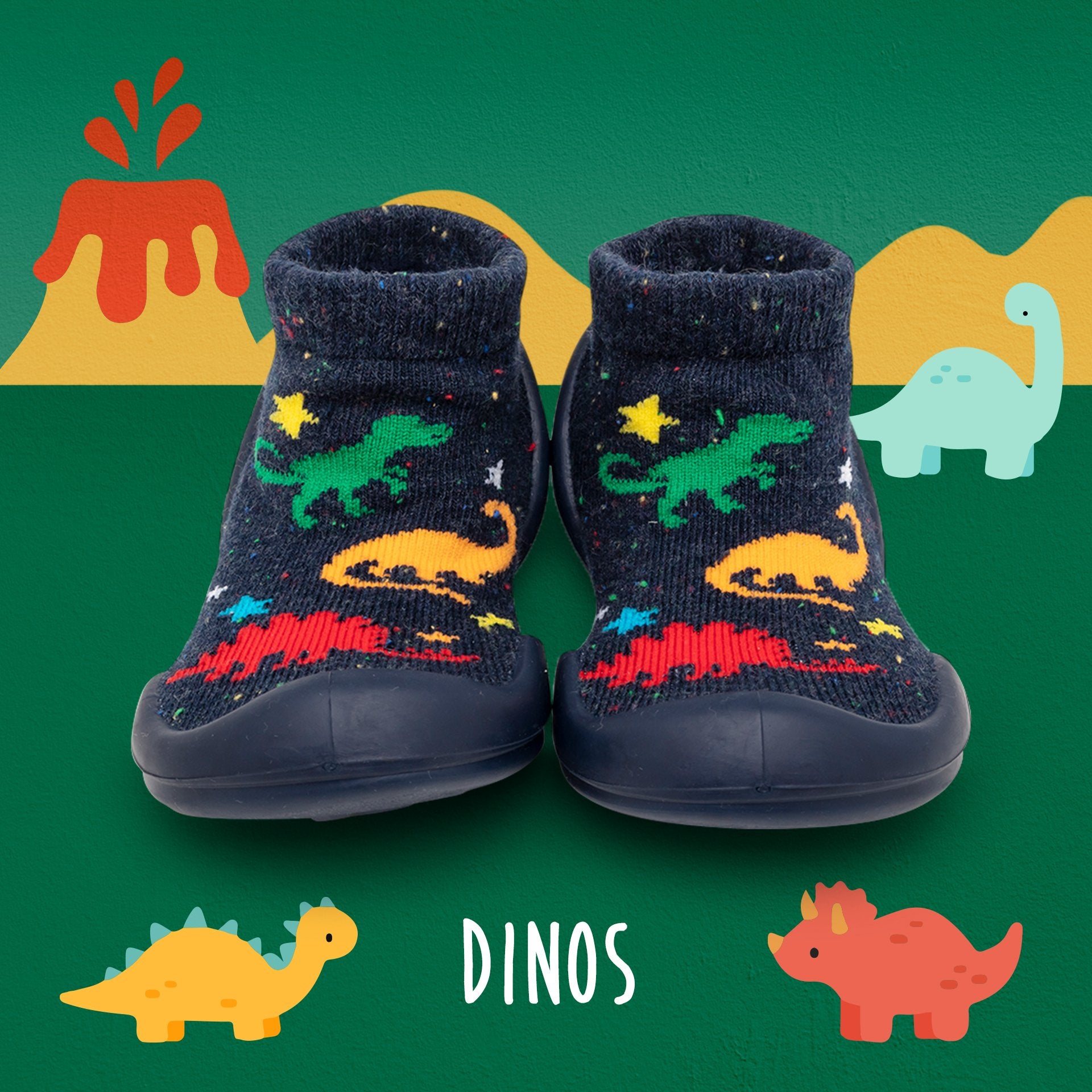 Dark blue toddler sock-shoes with dinosaur patterns, on a dinosaur themed background.