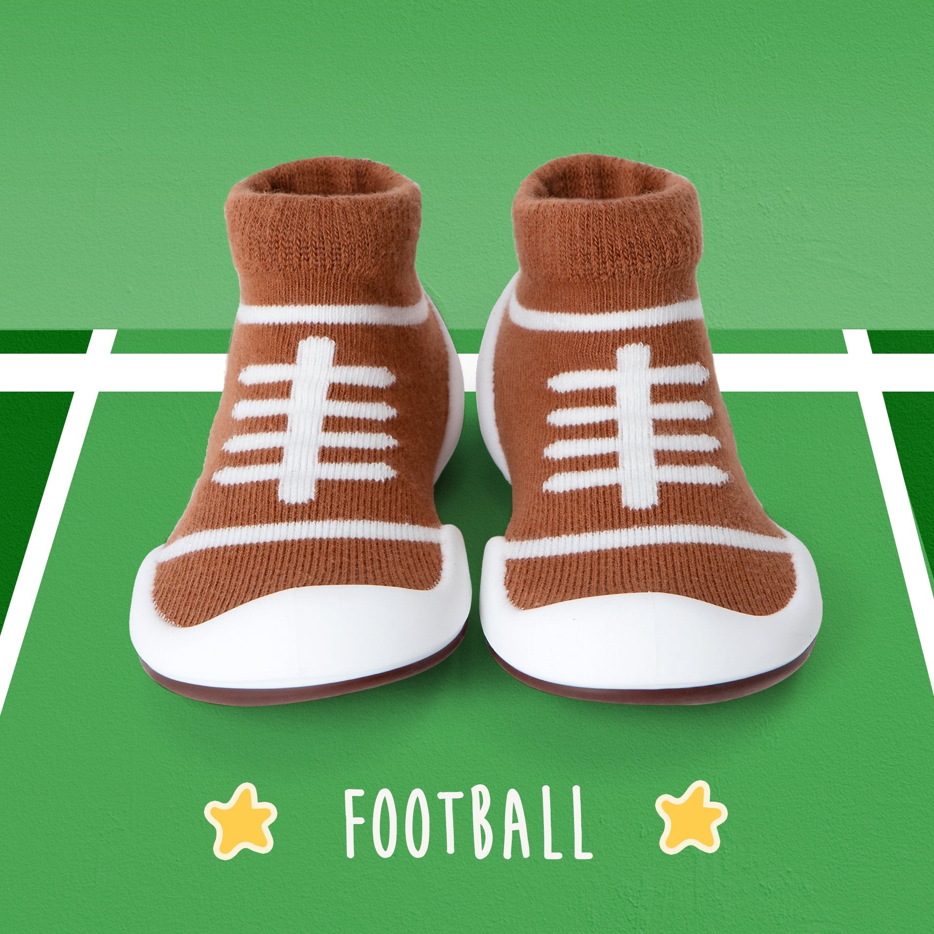 Two baby sock shoes, football design, green background.
