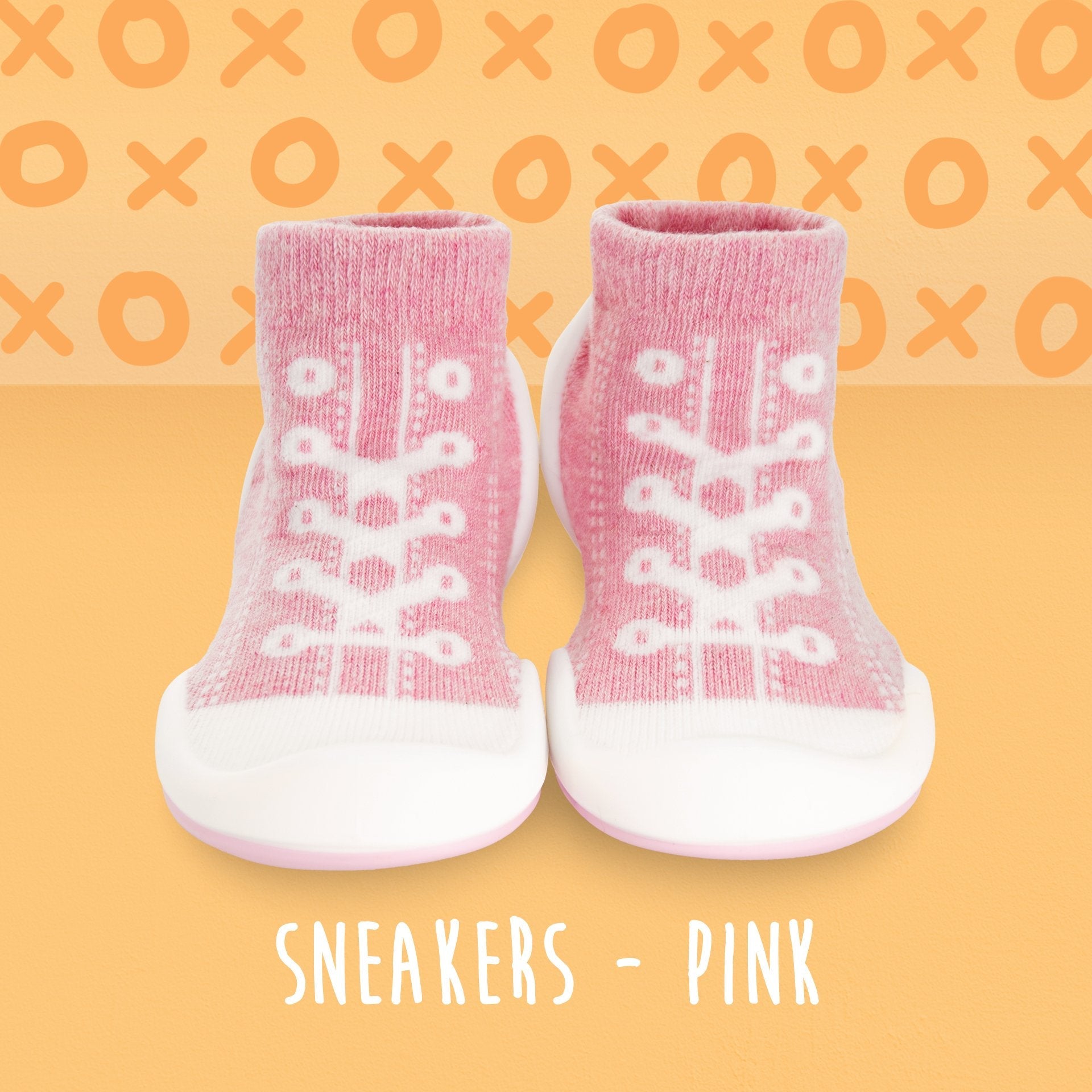 Pair of pink baby sneakers with white soles.