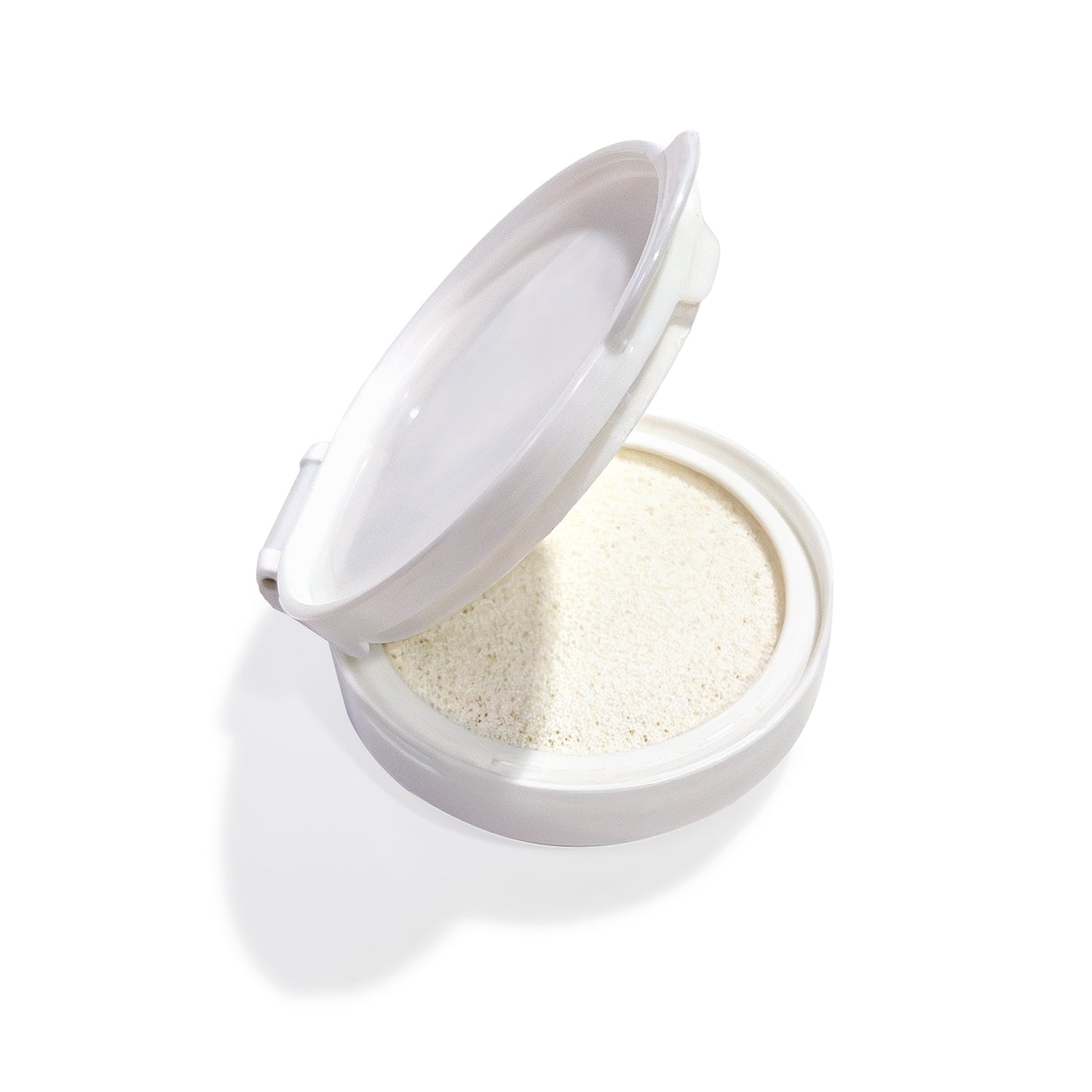 Open white compact with porous white sponge inside.