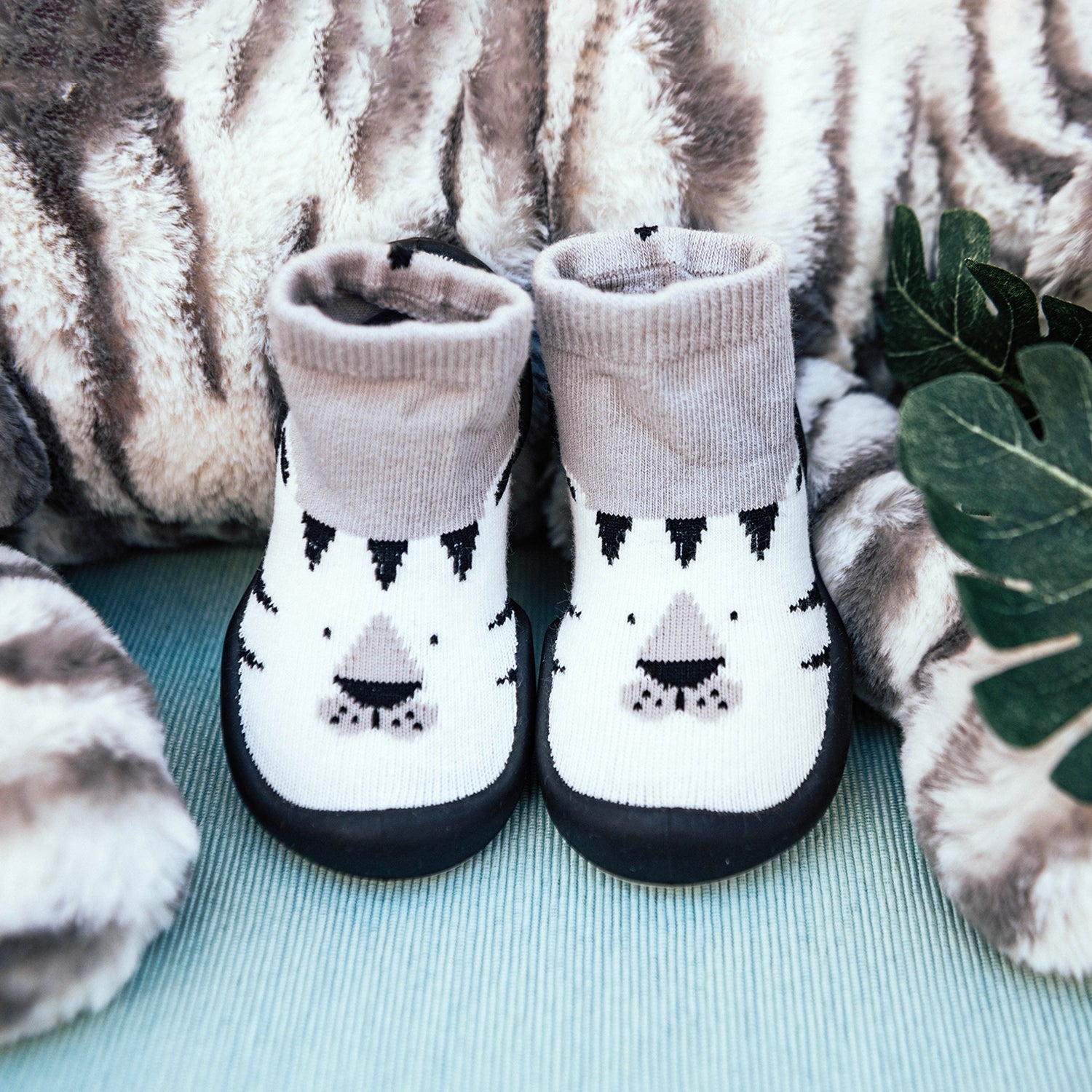 Two baby tiger socks with dark soles.
