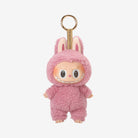 Pink, fuzzy monster toy with bunny ears.
