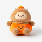 A cute plush toy character dressed in a pumpkin costume, featuring a brown fuzzy monster body with small horns, a smiling face, and an orange pumpkin-shaped outfit with a jack-o'-lantern face.