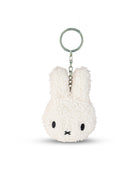 White plush keychain with a face on a white background