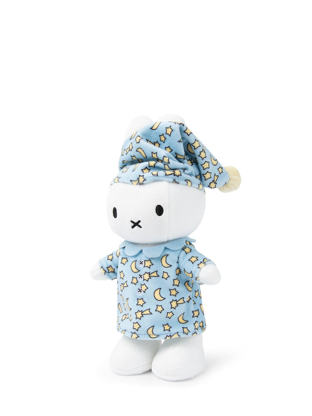 Stuffed toy resembling a cat in blue pajamas with star and moon pattern and matching cap on a white background