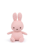 Pink quilted Miffy plush toy sitting.
