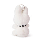 White plush keychain with a black belt on a white background