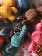 Collection of colorful plush keychains on a textured surface